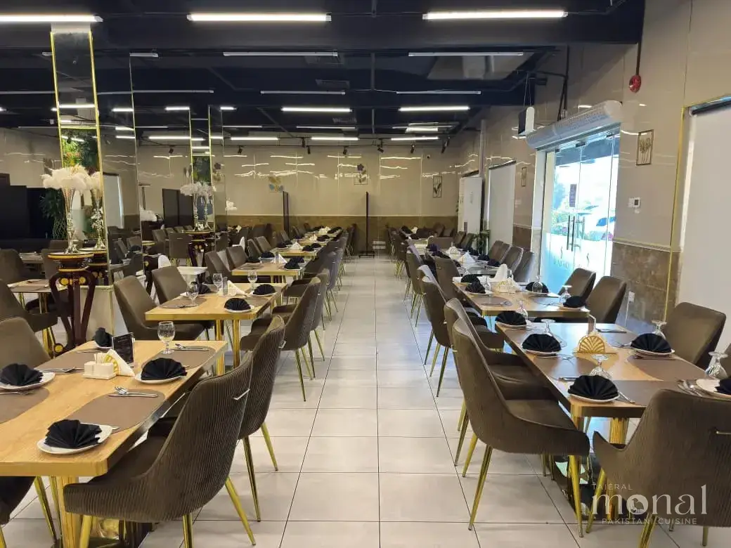 The long dining hall at Taier Al Monal, laid with rows of set tables